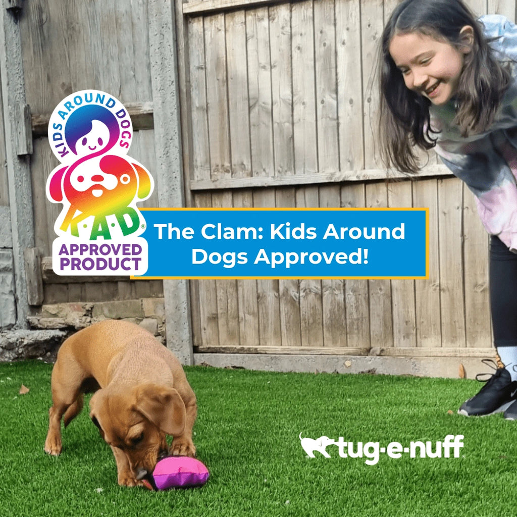 Kids Around Dogs Approved Logo with Child Playing with Clam Treat toy and Dog.